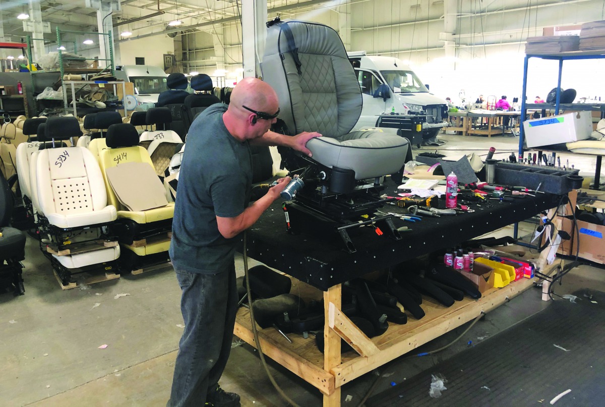 An assembly line worker works on the production line at Midwest Automotive Designs in Bristol, Indiana, U.S., April 16, 2019. Reuters/Tim Aeppel
