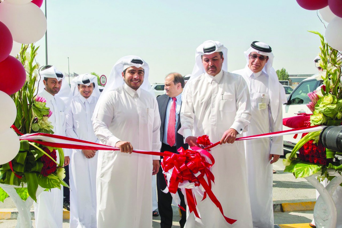 Commercial Bank Board Member, Sheikh Faisal bin Fahad bin Jassim Al Thani (foreground, right), formally opening the bank’s Ain Khaled branch as President and CEO of Milaha, Abdulrahman Al Mannai (foreground, left), and other officials look on. 