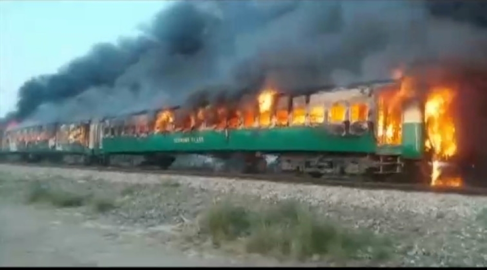 A fire burns a train carriage after a gas canister passengers were using to cook breakfast exploded, near the town of Rahim Yar Khan in the south of Punjab province, Pakistan October 31, 2019, in this still image take from video. REUTERS