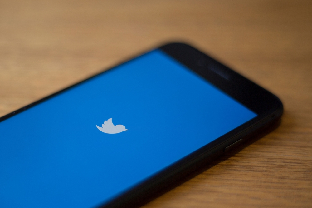 (FILES) In this file photo taken on July 10, 2019, the Twitter logo is seen on a phone in this photo illustration in Washington, DC. AFP / Alastair Pike