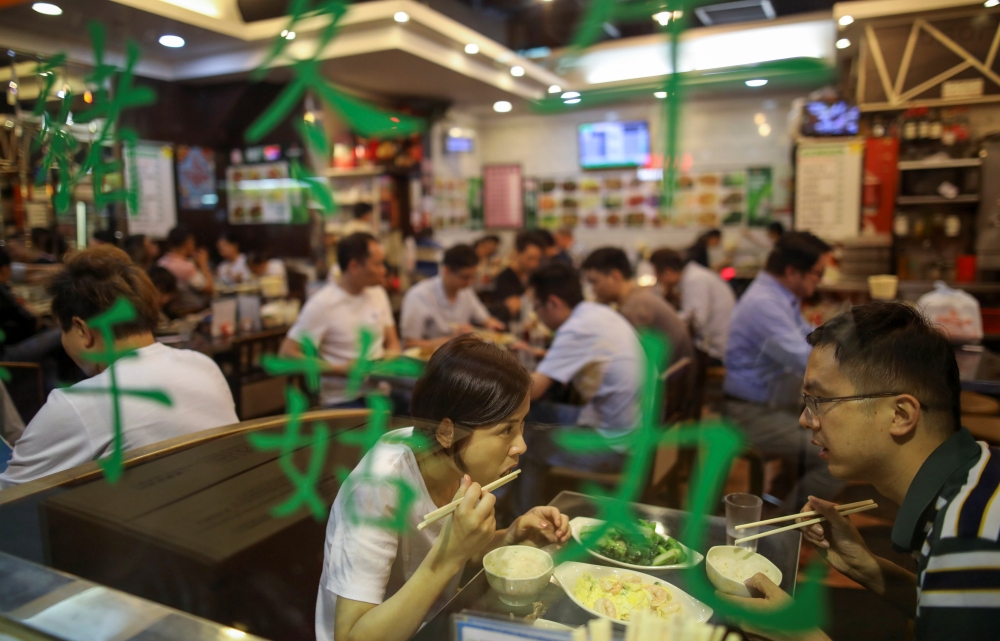 People eat inside a restaurant in Hong Kong, China October 25, 2019. REUTERS