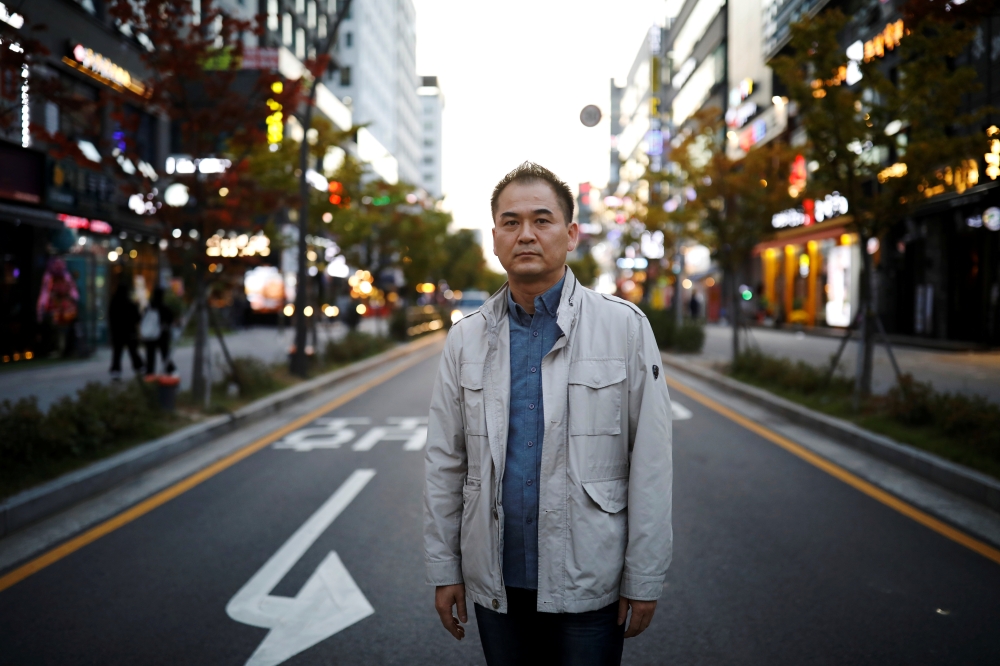 Park Chol-hee, whose brother was killed in a crane collapse in 2017 at a Samsung shipyard, poses for photographs in Seoul, South Korea, October 18, 2019. Reuters/Kim Hong-Ji
 