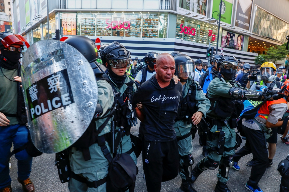 Riot policemen detain a man in Causeway Bay district before a protest march in Hong Kong, China November 2, 2019. REUTERS/Thomas Peter