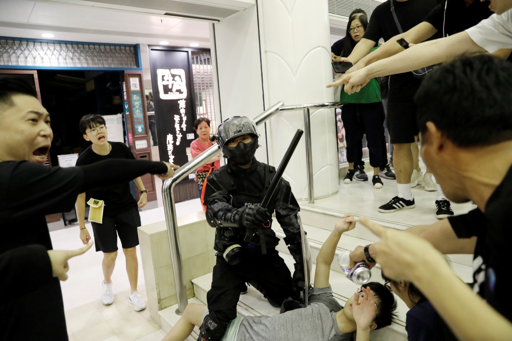 Riot police officer detains a protester at a shopping mall in Tai Po in Hong Kong, China November 3, 2019. REUTERS/Kim Kyung-Hoon