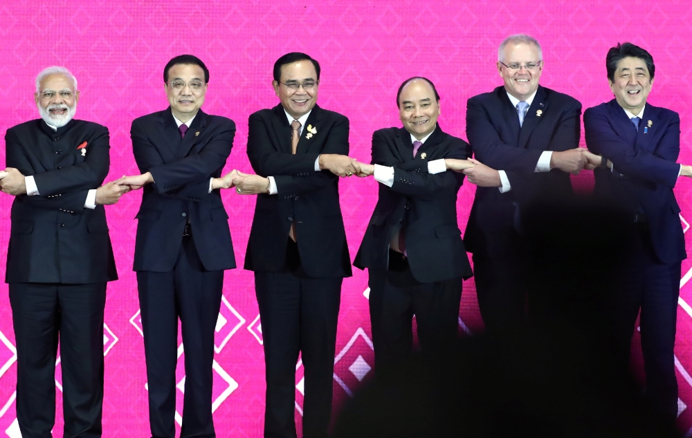 India's Prime Minister Narendra Modi, Chinese Premier Li Keqiang, Thai Prime Minister Prayuth Chan-Ocha, Vietnam's Prime Minister Nguyen Xuan Phuc, Australia's Prime Minister Scott Morrison and Japan's Prime Minister Shinzo Abe shake hands at the 3rd Regi