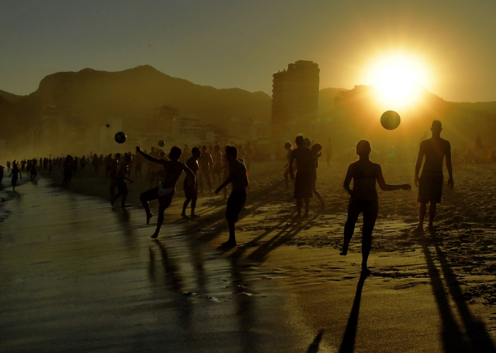 Beachgoers play with balls at Ipanema Beach in Rio de Janeiro on June 29, 2019. AFP / Carl De Souza