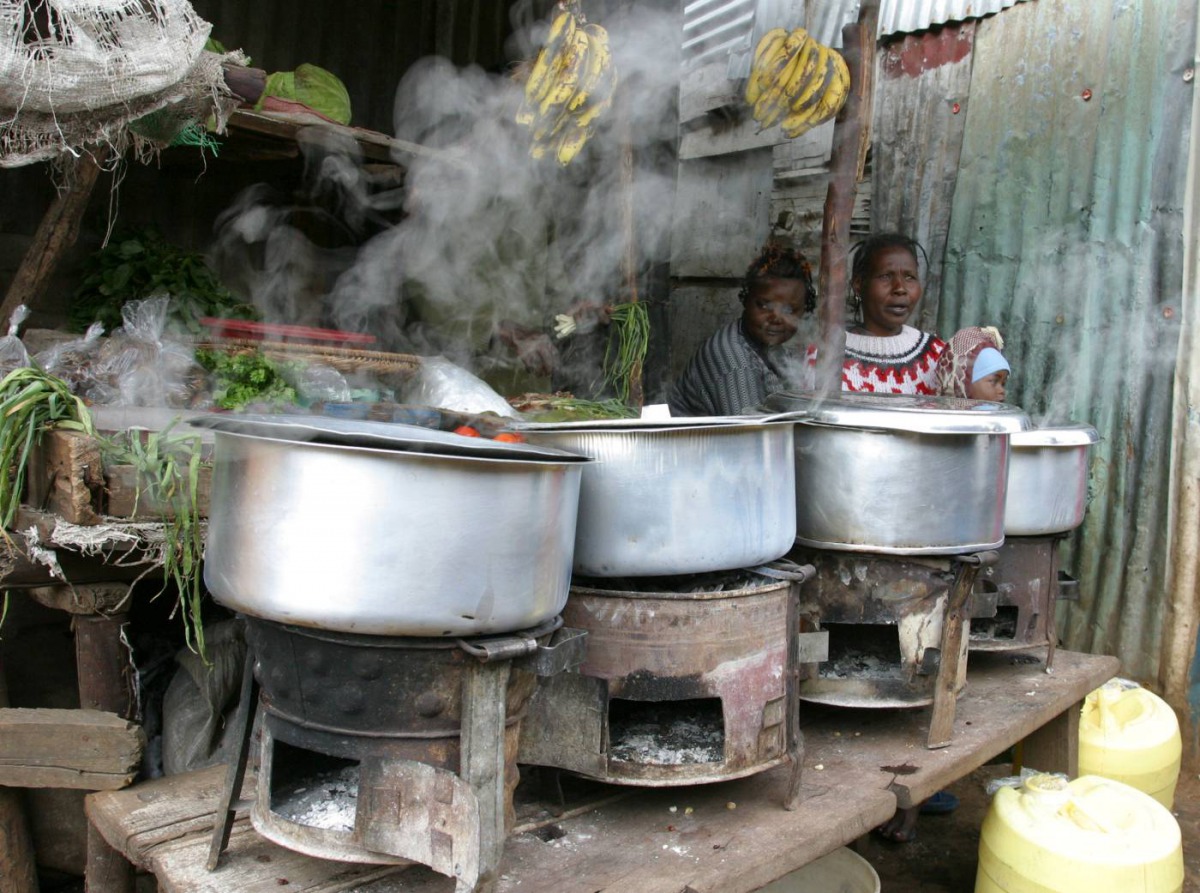 Women sit next to their cooking stoves at the sprawling Kibera slums in Kenya's capital Nairobi, June 8, 2009. Reuters/Noor Khamis