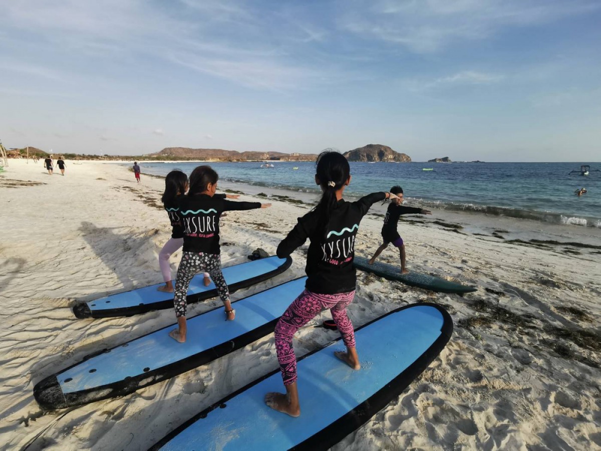 Young Indonesian female surfers seen during a practice session in Lombok, Indonesia October 8, 2019. Thomson Reuters Foundation/Beh Lih Yi