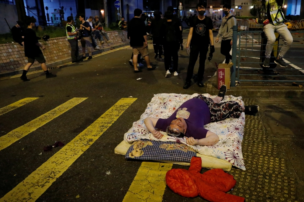 Anti-government protester lies on a mattress during a protest, following 22 year-old University student's fall and who was critically injured last weekend, in Tseung Kwan O, Hong Kong, China November 6, 2019. Reuters/Tyrone Siu