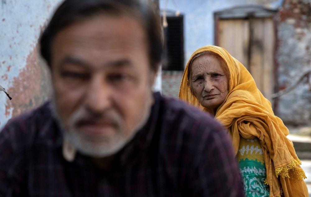 Zaibunissa, whose husband was killed during riots following the demolition of Babri Masjid, sits with her son Mohammed Shahid outside their house in Ayodhya, India, October 22, 2019. Reuters/Danish Siddiqui