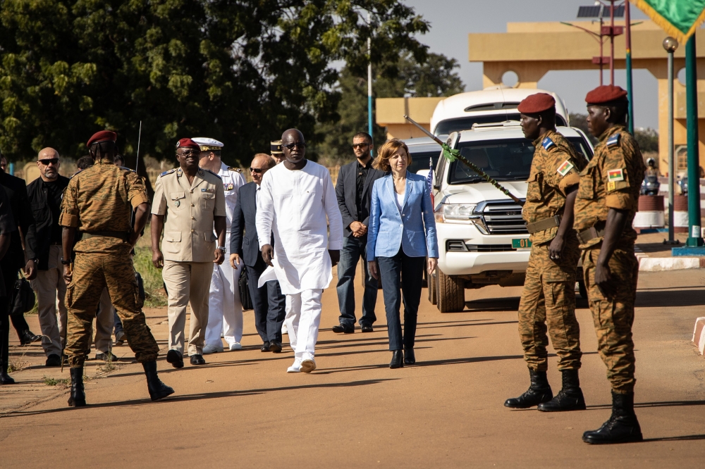 Cherif Sy, Burkina Faso's Defense Minister (C,L) and Florence Parly, France's Defense Minister (C,R) review the troops during a visit at the Burkinabe minister of Defense in Ouagadougou, on Novembrer 4, 2019. AFP / Olympia De Maismont
 