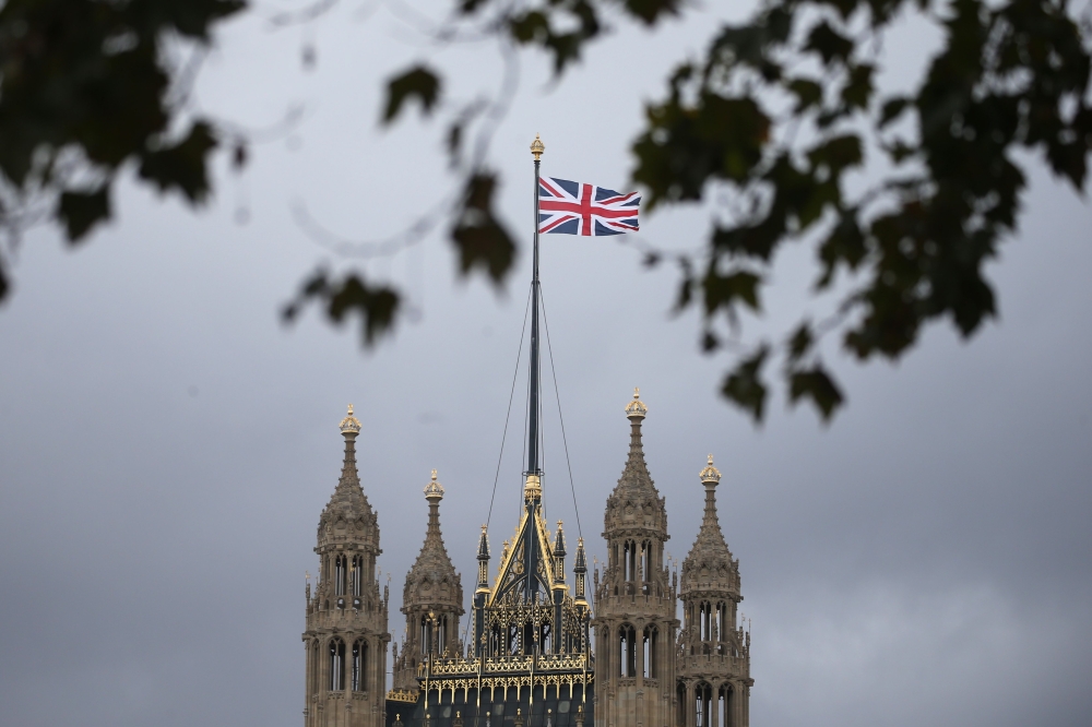 A Union flag flies over the Houses of Parliament in central London on October 29, 2019. AFP / Isabel Infantes