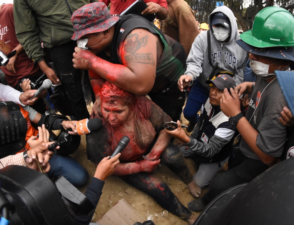 The mayor of the Bolivian town of Vinto and member of his ruling Movement for Socialism (MAS) party, Patricia Arce, speaks to the press as she is being humiliated by a mob of opposition supporters, in Vinto, close to Cochabamba, on November 6, 2019. AFP 