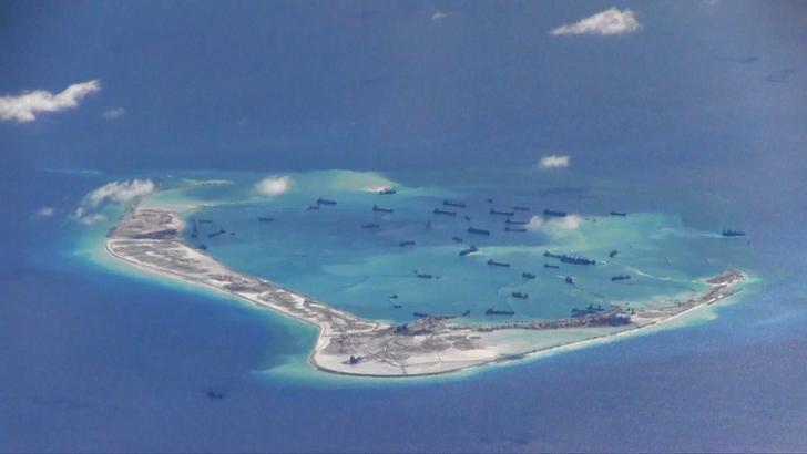 Chinese dredging vessels are purportedly seen in the waters around Mischief Reef in the disputed Spratly Islands in the South China Sea, May 21, 2015. US Navy Handout via Reuters