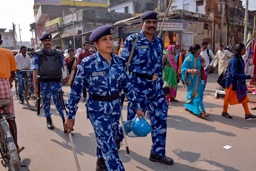 Rapid Action Force (RPF) personnel patrol on a street in Ayodhya on November 8, 2019, ahead of a Supreme Court verdict on the future of a disputed religious site. Indian police have arrested more than 500 people ahead of a Supreme Court ruling on a hotly 