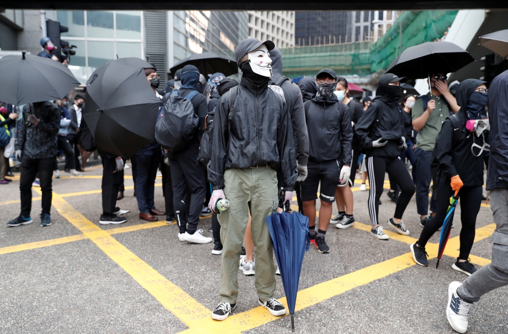 A demonstrator wears a Guy Fawkes mask during an anti-government protest in Central, Hong Kong, China November 12, 2019. REUTERS/Shannon Stapleton
