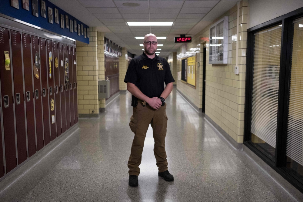 School resource officer, John Pence, who serves as an extra precaution to help keep students safe in the building, poses at Sidney High School in Sidney, Ohio, October 31, 2019. AFP / Megan Jelinger 