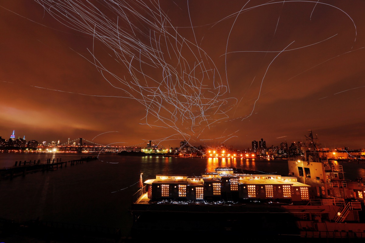LED lights attached to pigeons leave light trails in the sky while they fly as part of the Fly By Night art installation by Duke Riley above the Brooklyn borough of New York, May 5, 2016. Reuters / Lucas Jackson