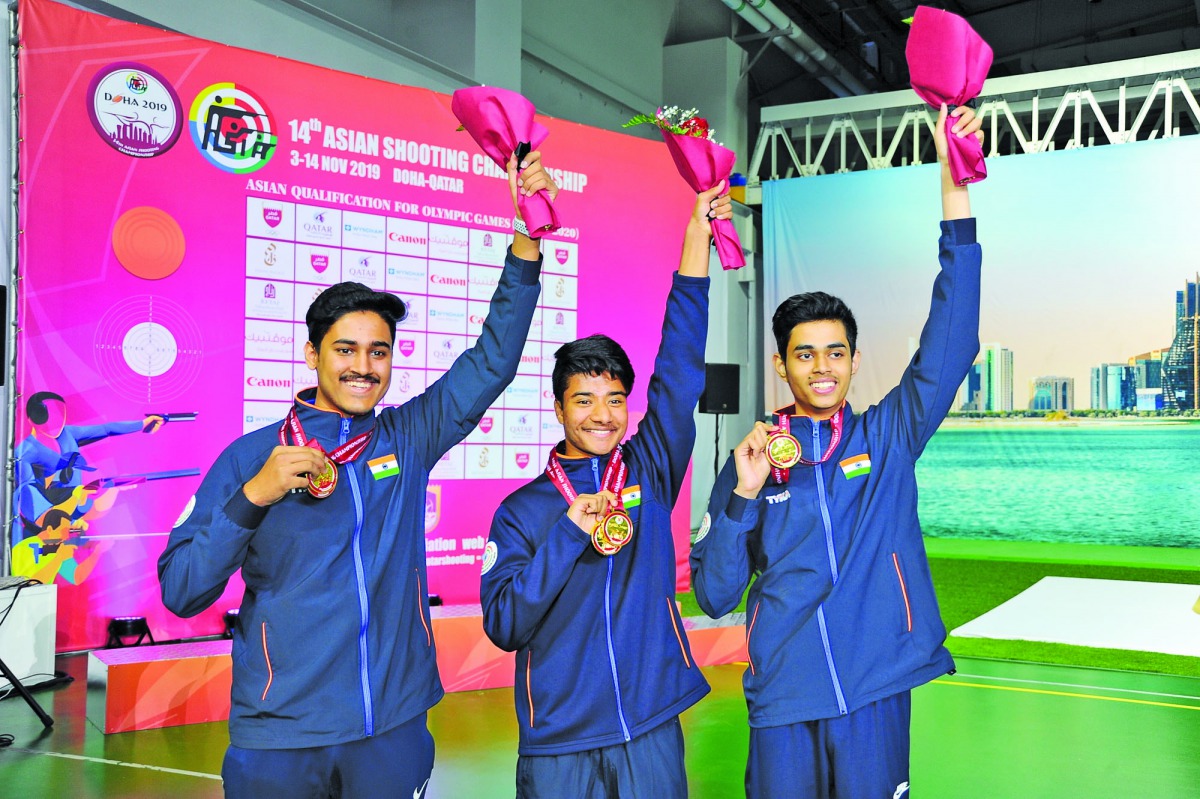 Dhanush Srikanth (centre) celebrates his gold medal with other medal winning shooters yesterday.
