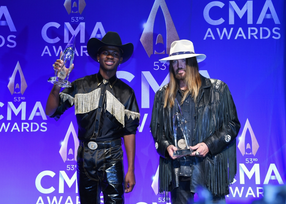 Lil Nas X and Billy Ray Cyrus speak backstage with their Musical Event of the Year award for 