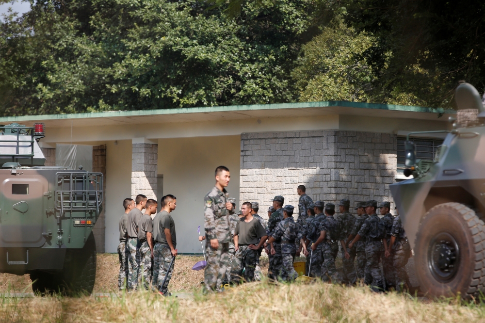 People's Liberation Army (PLA) vehicles and troops are seen inside the Tam Mei PLA base in Hong Kong's northern New Territories, China November 16, 2019. REUTERS/James Pomfret