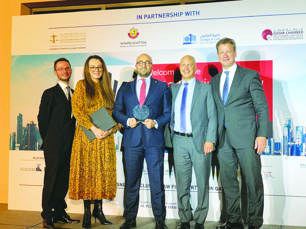 The senior officials and awardees posing for a group picture at the Qatar Business Law Awards ceremony held at The St. Regis Hotel in Doha on November 12, 2019.