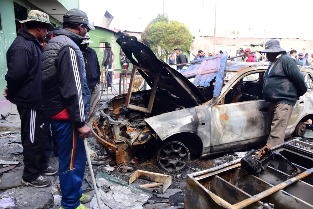 Burned vehicles are seen at a transit station after protests on Friday night, following former Bolivian President Evo Morales' exit from the country, in El Alto, Bolivia, November 16, 2019. REUTERS/Andrea Martinez