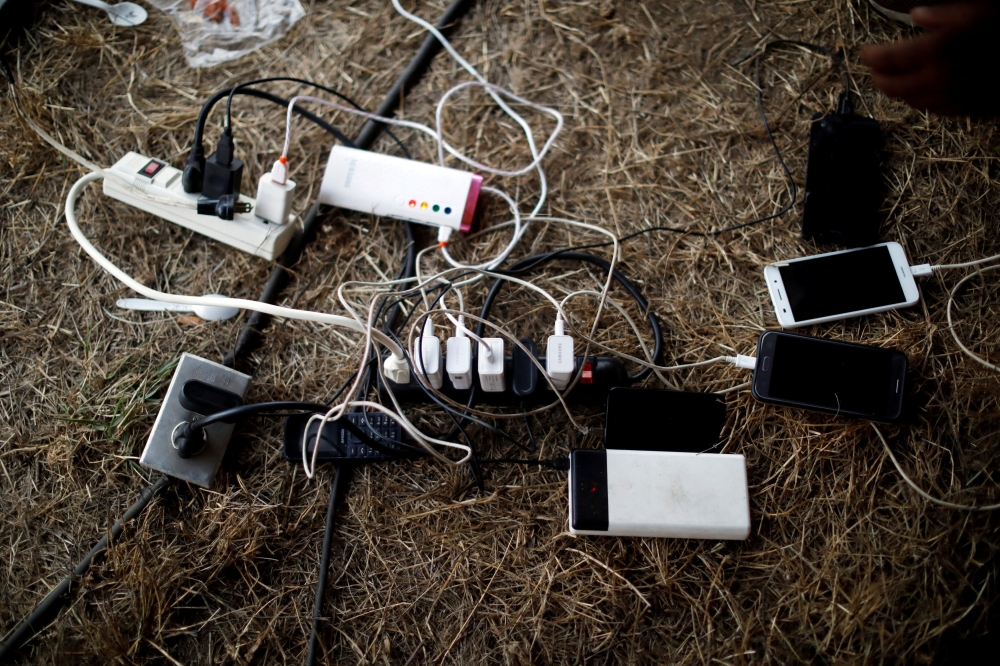 Mobile devices belonging to Cuban migrants are seen charging at an improvised shelter as they wait for a humanitarian visa to the United States in Mapastepec Chiapas state, Mexico, April 10, 2019. Reuters /  Jose Cabezas