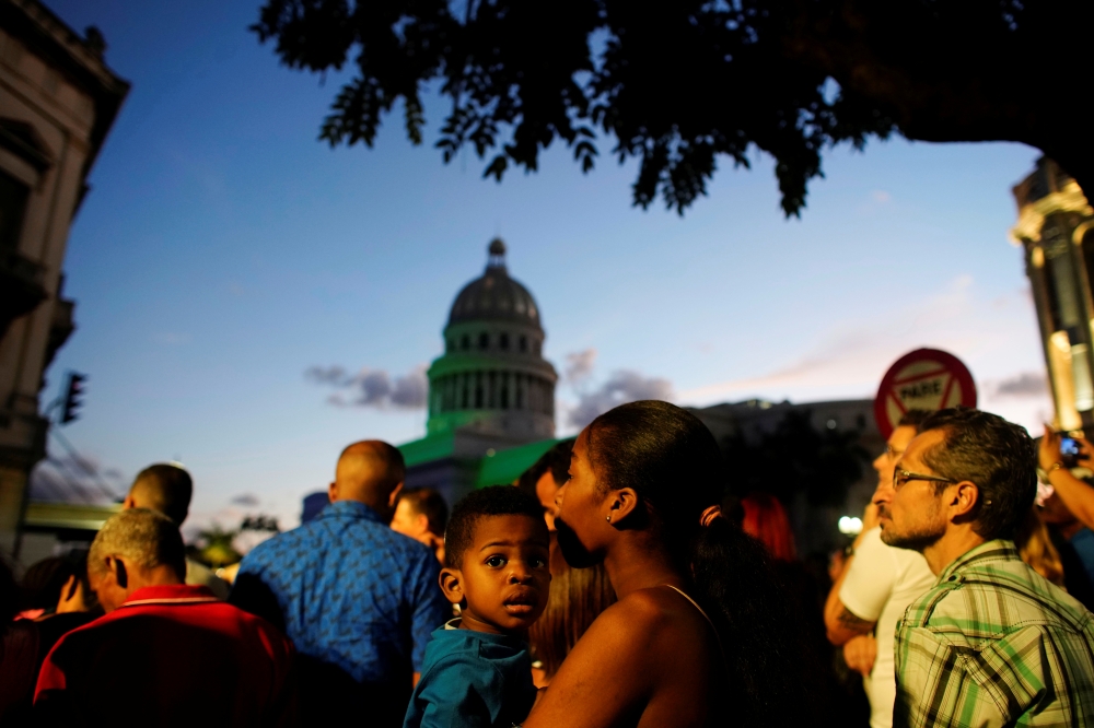 People wait for fireworks during the celebrations of the 500th anniversary of the city, Havana, Cuba, November 16, 2019. Reuters/Alexandre Meneghini