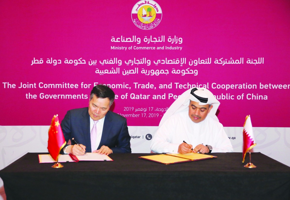 H E Ali bin Ahmed Al Kuwari (right), Minister of Commerce and Industry; and Qian Keming, China’s Vice-Minister of Commerce, signing minutes of the meeting.
