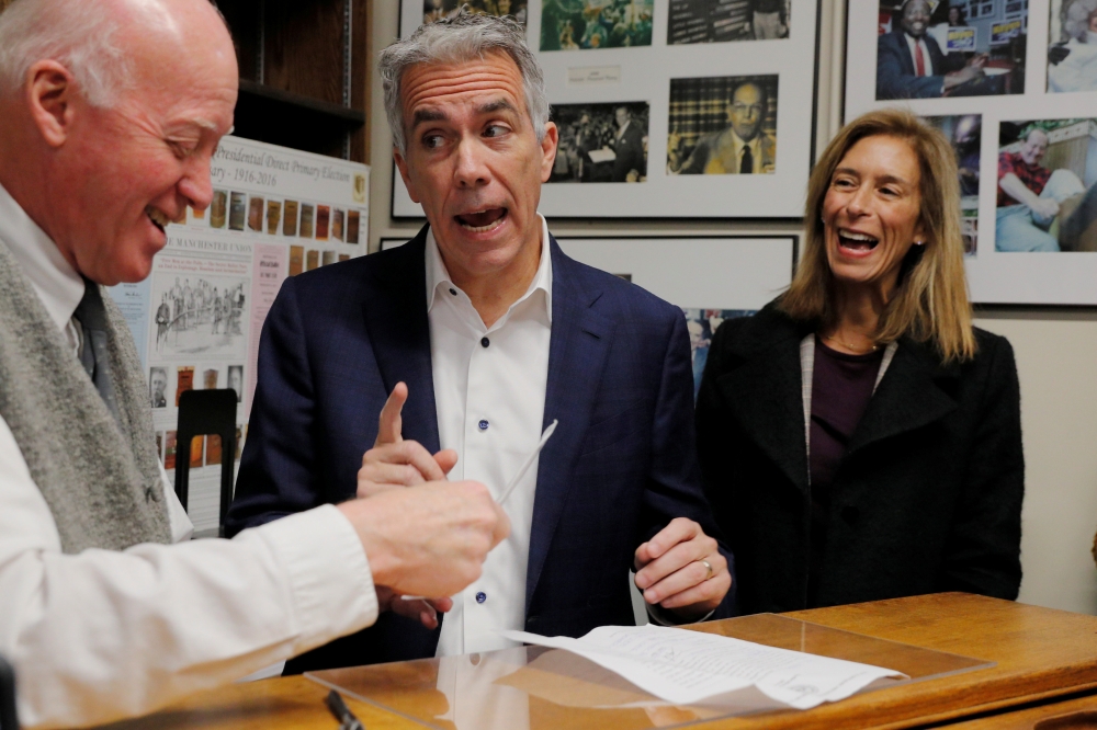 Republican 2020 US presidential candidate Joe Walsh, with his wife Helene at his side, files paperwork with New Hampshire Secretary of State Bill Gardner for his name to appear on the state’s first-in-the-nation primary ballot in Concord, New Hampshire, U