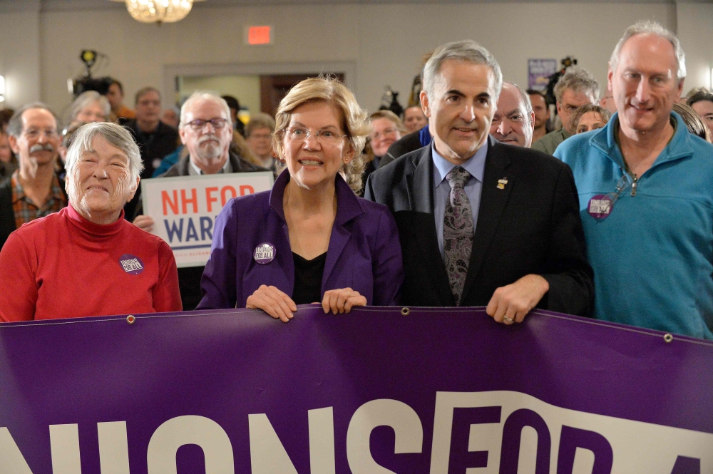 Democratic presidential hopeful Massachusetts' Senator Elizabeth Warren takes a group photo with members of SEA/SEIU Local 1984, state employees, at the Holiday Inn in Concord New Hampshire, after signing papers to officially enter the New Hampshire Prima