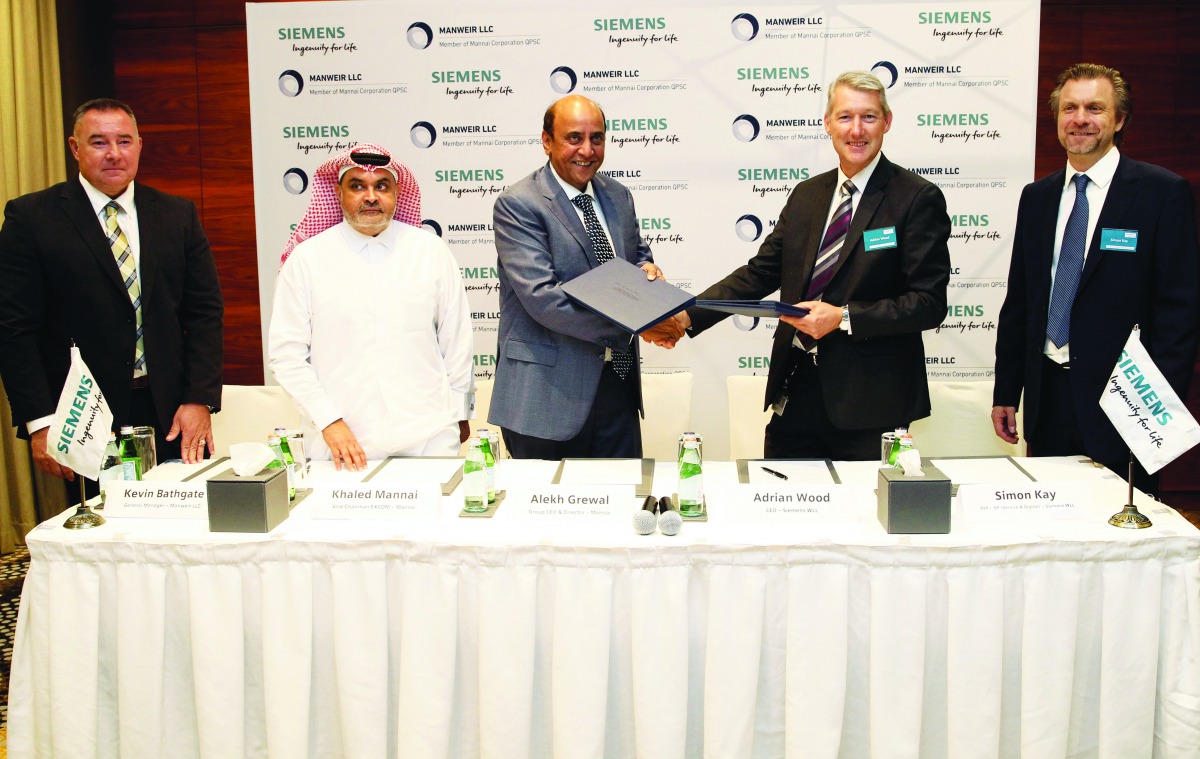 Alekh Grewal (third left), Group CEO & Director, Mannai Corporation, and Adrian Wood, CEO, Siemens Qatar, exchanging signed contracts during a press event held at Hotel InterContinental The City. Pic: Qassim Rahmatullah/the peninsula