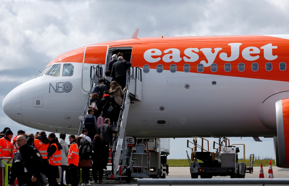 Passengers board an easyJet plane at the Nantes-Atlantique airport in Bouguenais near Nantes, France, April 4, 2019. Reuters/Stephane Mahe
