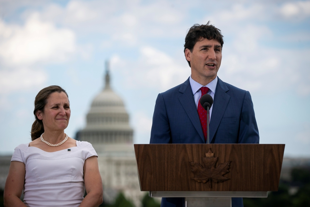 File photo of Canada's Prime Minister Justin Trudeau speaks as Canada's Foreign Minister Chrystia Freeland listens during a news conference at the Canadian Embassy, in Washington, U.S. June 20, 2019. REUTERS/Al Drago/File Photo