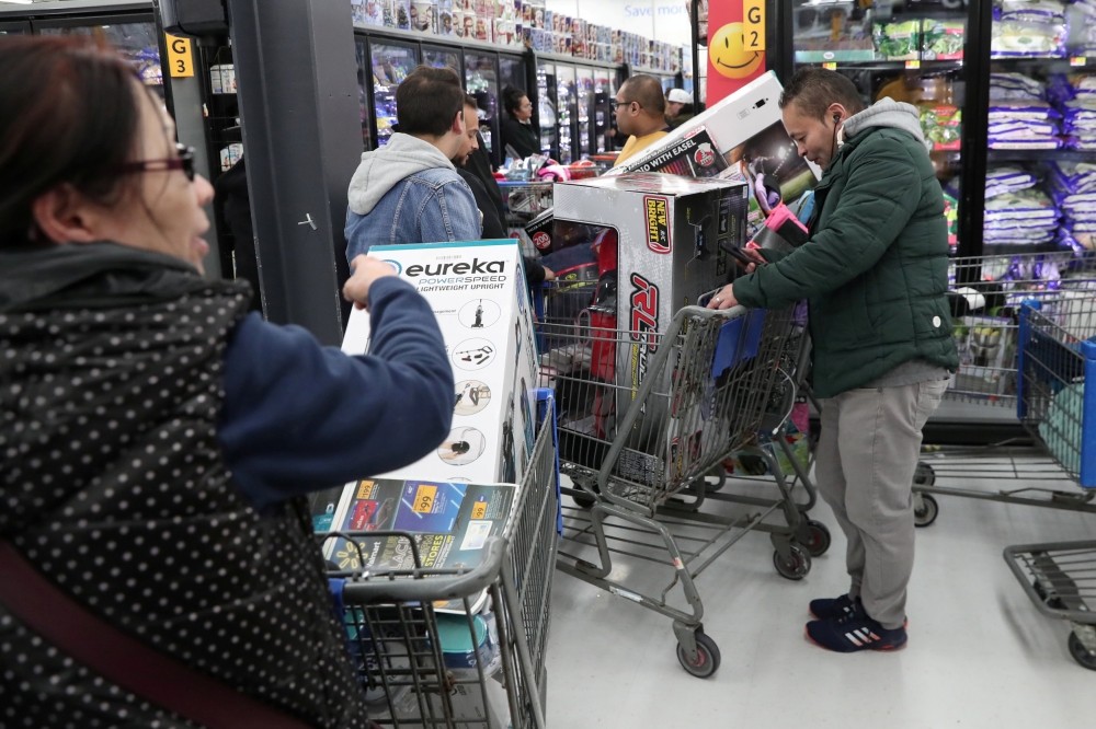People wait in line pay at a Walmart during a sales event on Thanksgiving day in Westbury, New York, US, November 22, 2018. Reuters / Shannon Stapleton