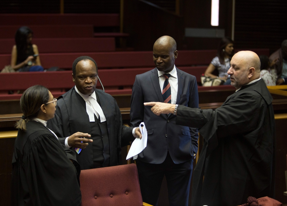 Advocate Muzi Sikhakhane (2ndL), part of former South African President Jacob Zuma's legal team, speaks to advocate Anton Katz (R), legal representative of the French Defence company Thales, before the trail of South Africa's embattled former president Ja