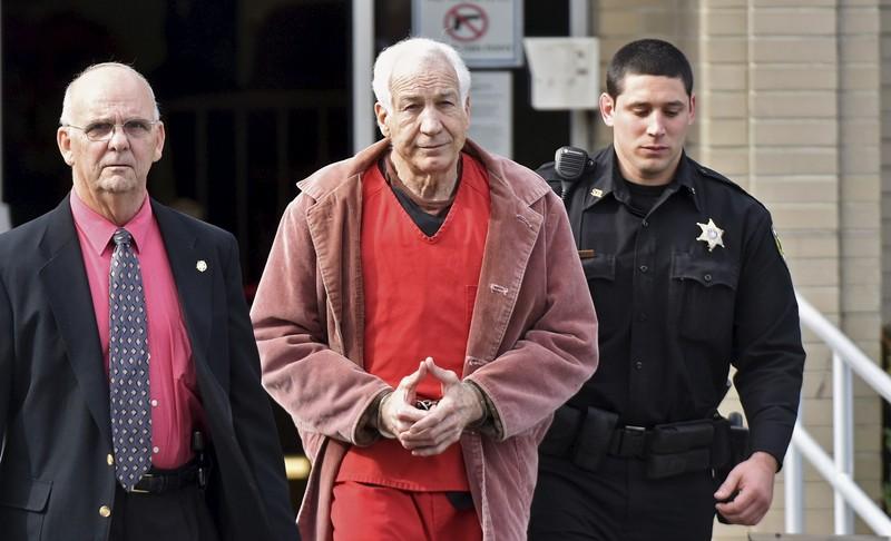 Convicted child molester Jerry Sandusky (C), a former assistant football coach at Penn State University, leaves after his appeal hearing at the Centre County Courthouse in Bellefonte, Pennsylvania, US on October 29, 2015. Reuters/Pat Little
 