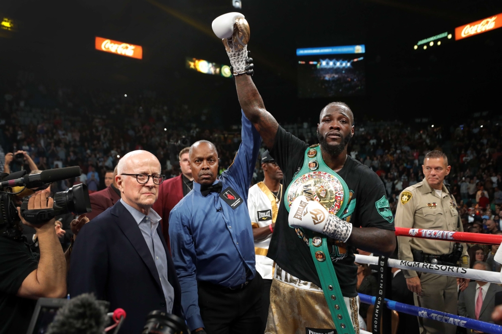 WBC heavyweight champion Deontay Wilder poses with referee Kenny Bayless after defeating Luis Ortiz in their title fight at MGM Grand Garden Arena on November 23, 2019, in Las Vegas, Nevada. Steve Marcus/Getty Images/AFP
