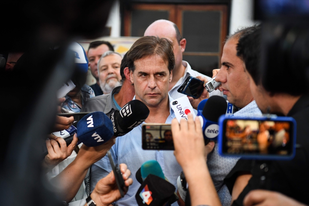 Partido Nacional party presidential candidate Luis Lacalle leaves after casting his vote at a polling station in Canelones, Uruguay during the run-off election on November 24, 2019 AFP / Pablo Porciuncula
 