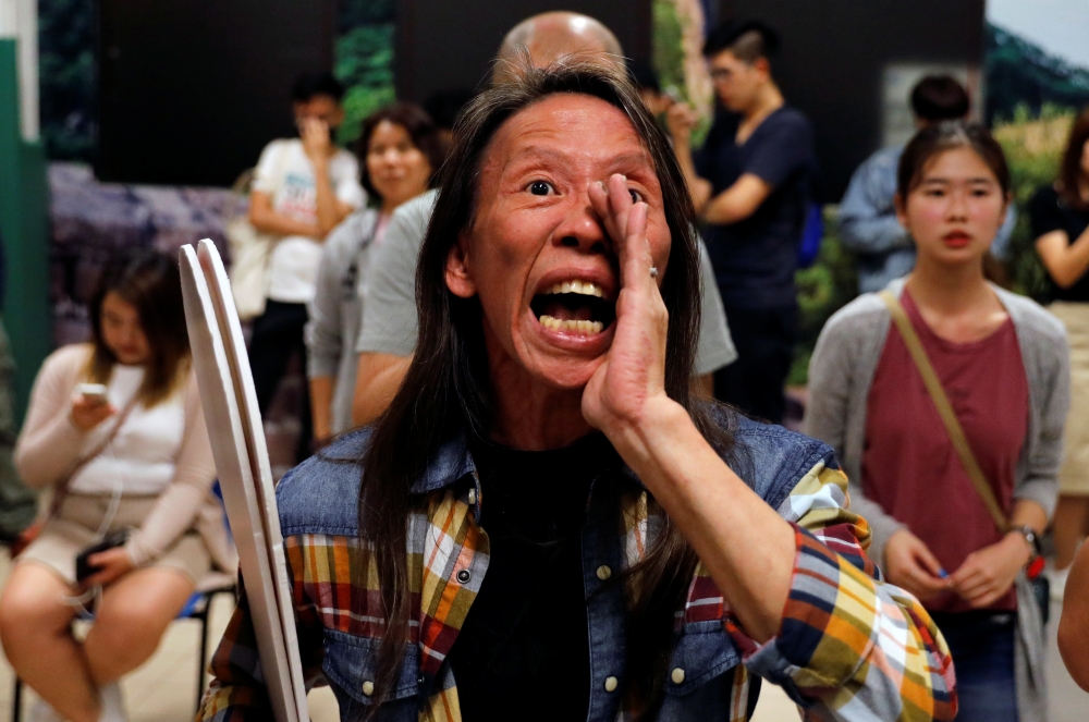 A woman reacts during the counting of the votes of the Hong Kong council elections, in a polling station in Hong Kong, China November 25, 2019. Reuters/Adnan Abidi