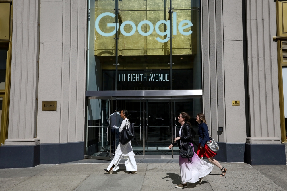 FILE PHOTO: People pass by an entrance to Google offices in New York, U.S., June 4, 2019. REUTERS/Brendan McDermid/File Photo
