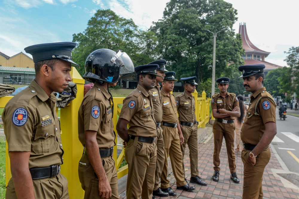 This photo taken on October 2, 2019 shows police officers standing outside the Supreme Court Complex of Sri Lanka in Colombo. The Sri Lankan government has put airports on alert to stop police detectives leaving without permission after a top officer who 