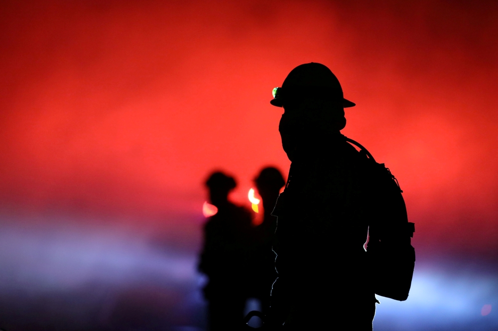Firefighters battle a wildfire dubbed the Cave Fire burning in the hills of Santa Barbara, California, US, November 26, 2019. Reuters/David McNew