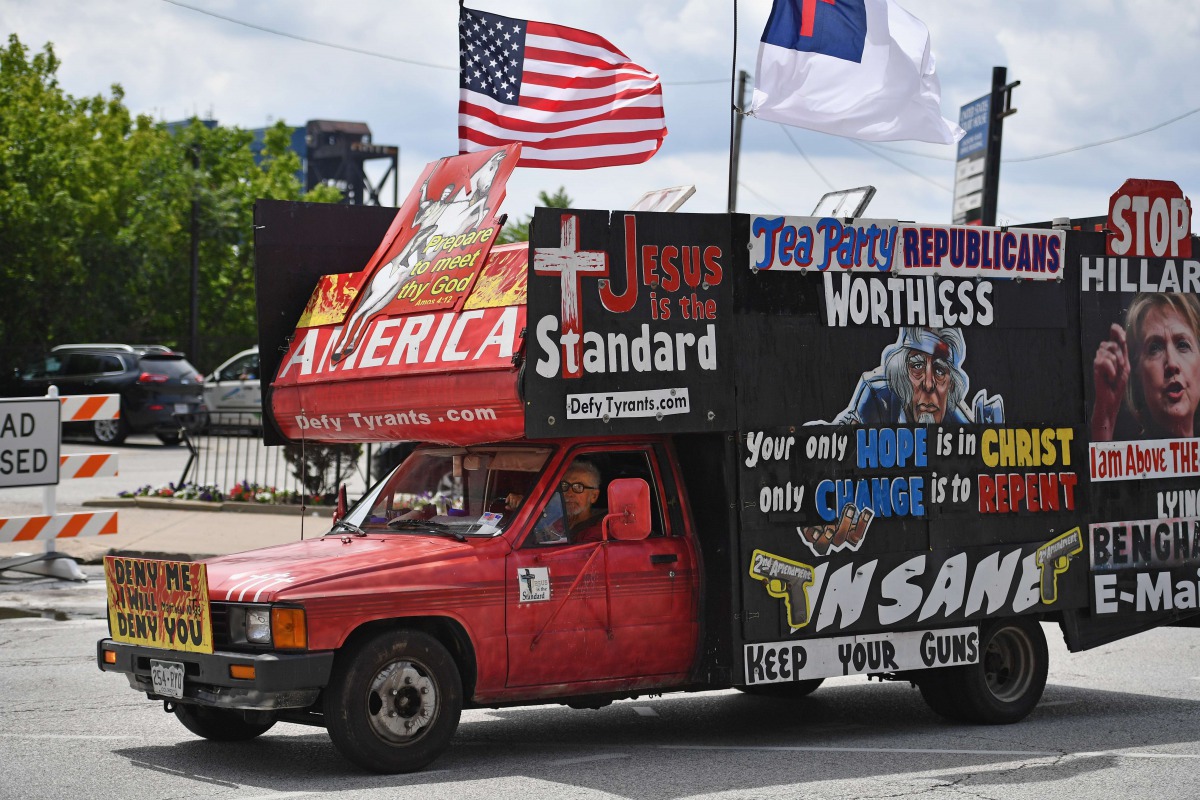 A man drives a pickup covered in billboards through downtown in the first day of the Republican National Convention on July 18, 2016, in Cleveland, Ohio. AFP / Getty Images