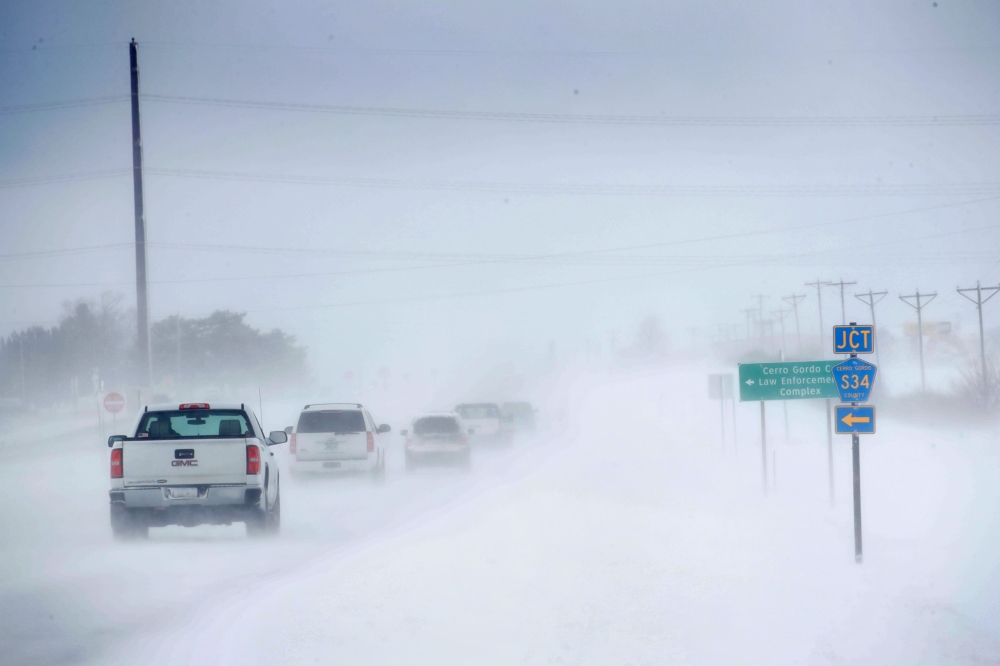 Motorists navigate an ice and snow-covered road on November 27, 2019 in Mason City, Iowa. Scott Olson/Getty Images/AFP