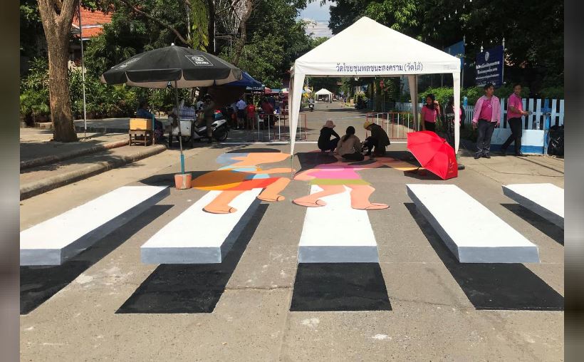 People paint a 3D pedestrian crossing in Kanchanaburi province, Thailand October 25, 2019. Picture taken October 25, 2019. REUTERS/Prapan Chankaew