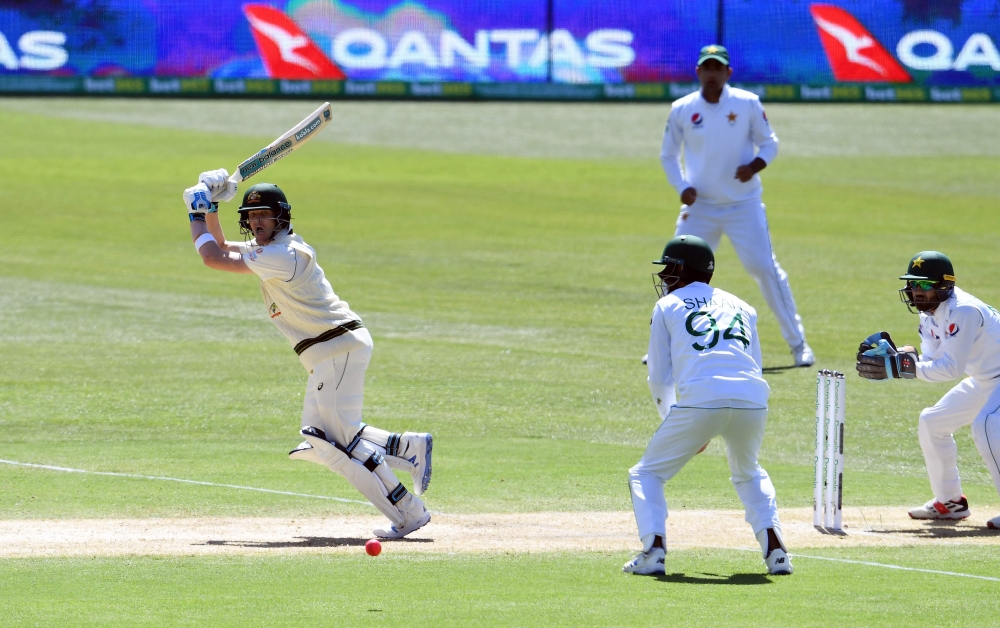 Australia's Steve Smith (L) plays a shot during the day two of the second cricket Test match between Australia and Pakistan in Adelaide on November 30, 2019. -- IMAGE RESTRICTED TO EDITORIAL USE - STRICTLY NO COMMERCIAL USE -- / AFP / William WEST /