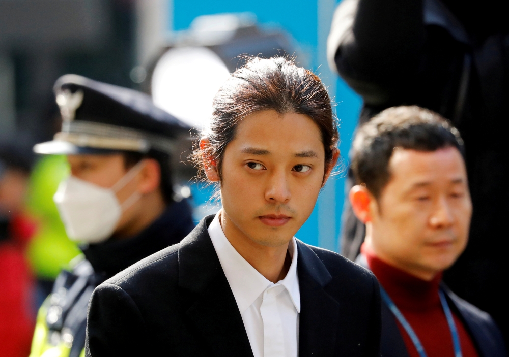 FILE PHOTO: South Korean singer Jung Joon-young arrives for questioning on accusations of illicitly taping and sharing sex videos on social media, at the Seoul Metropolitan Police Agency in Seoul, South Korea, March 14, 2019. REUTERS/Kim Hong-Ji/File Phot