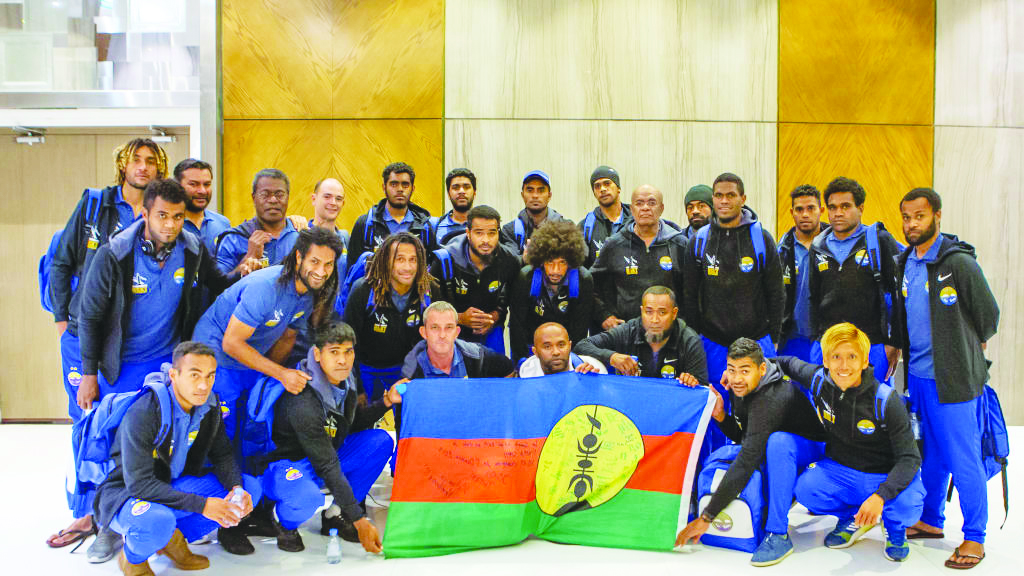 Hienghene Sport players and officials pose for a group photo upon their arrival in Doha.